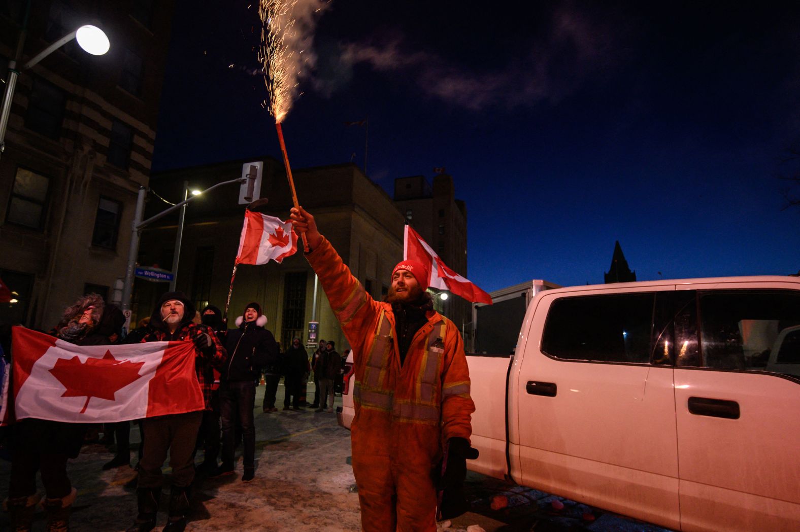 A demonstrator lets off a firework during a protest outside Parliament in Ottawa on February 12.