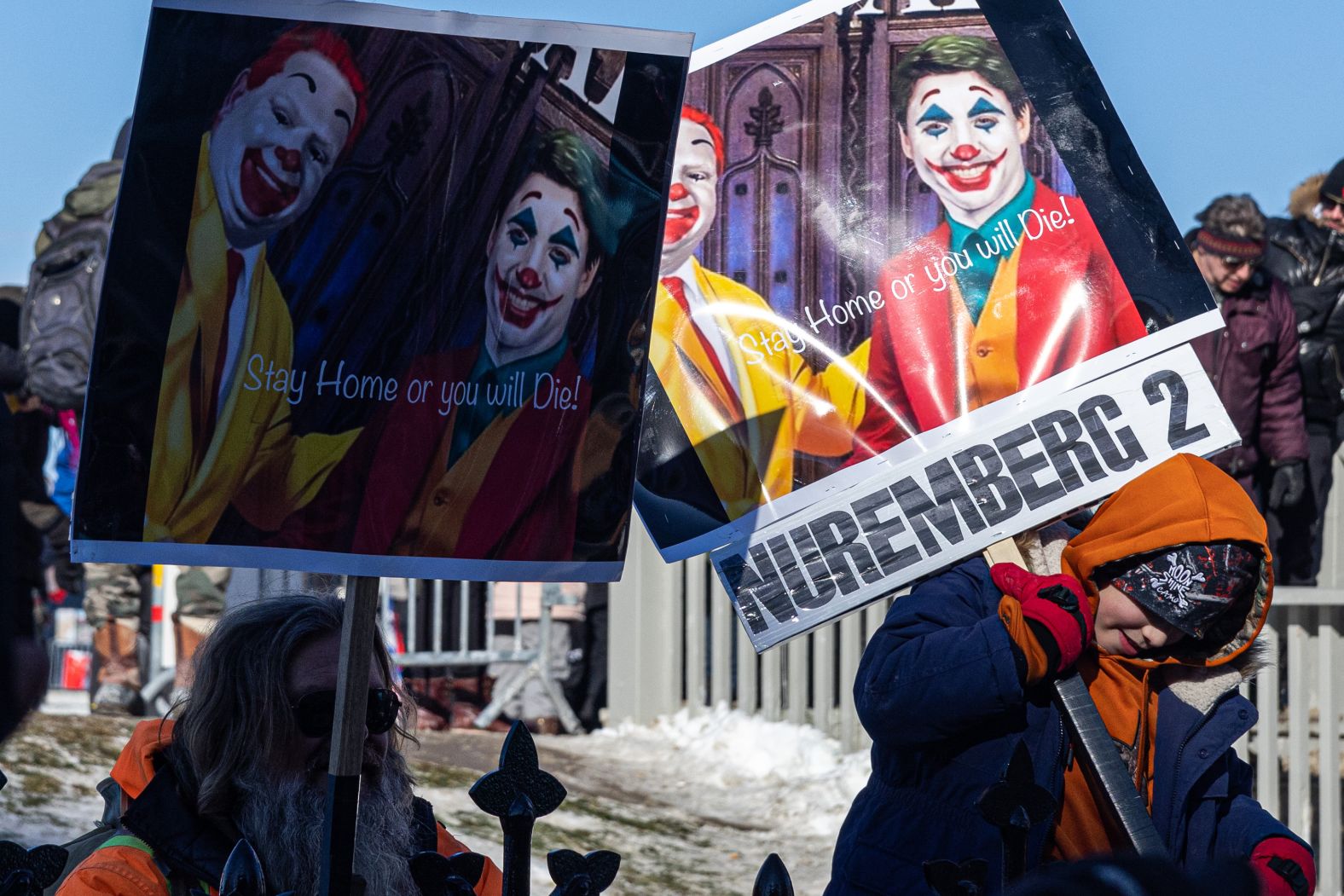 A child in Ottawa holds a sign comparing Covid-19 regulations to Nazi Germany on January 30.