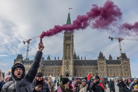 A man holds a firework during a protest in Ottawa on January 29.