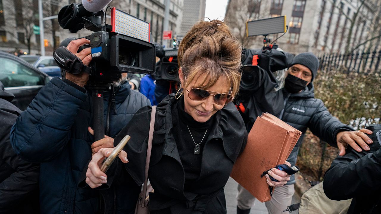 Former Alaska Gov. Sarah Palin pushes past members of the media as she leaves Federal court, Thursday, Feb. 3, 2022, in New York. Palin's libel suit against The New York Times went to trial Thursday in a case over the former Alaska governor's claims the newspaper damaged her reputation with an editorial linking her campaign rhetoric to a mass shooting (AP Photo/John Minchillo)