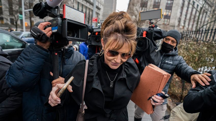 Former Alaska Gov. Sarah Palin pushes past members of the media as she leaves Federal court, Thursday, Feb. 3, 2022, in New York. Palin's libel suit against The New York Times went to trial Thursday in a case over the former Alaska governor's claims the newspaper damaged her reputation with an editorial linking her campaign rhetoric to a mass shooting (AP Photo/John Minchillo)