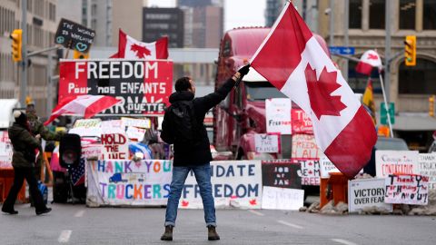 A protesters waves a flag Friday in Ottawa.