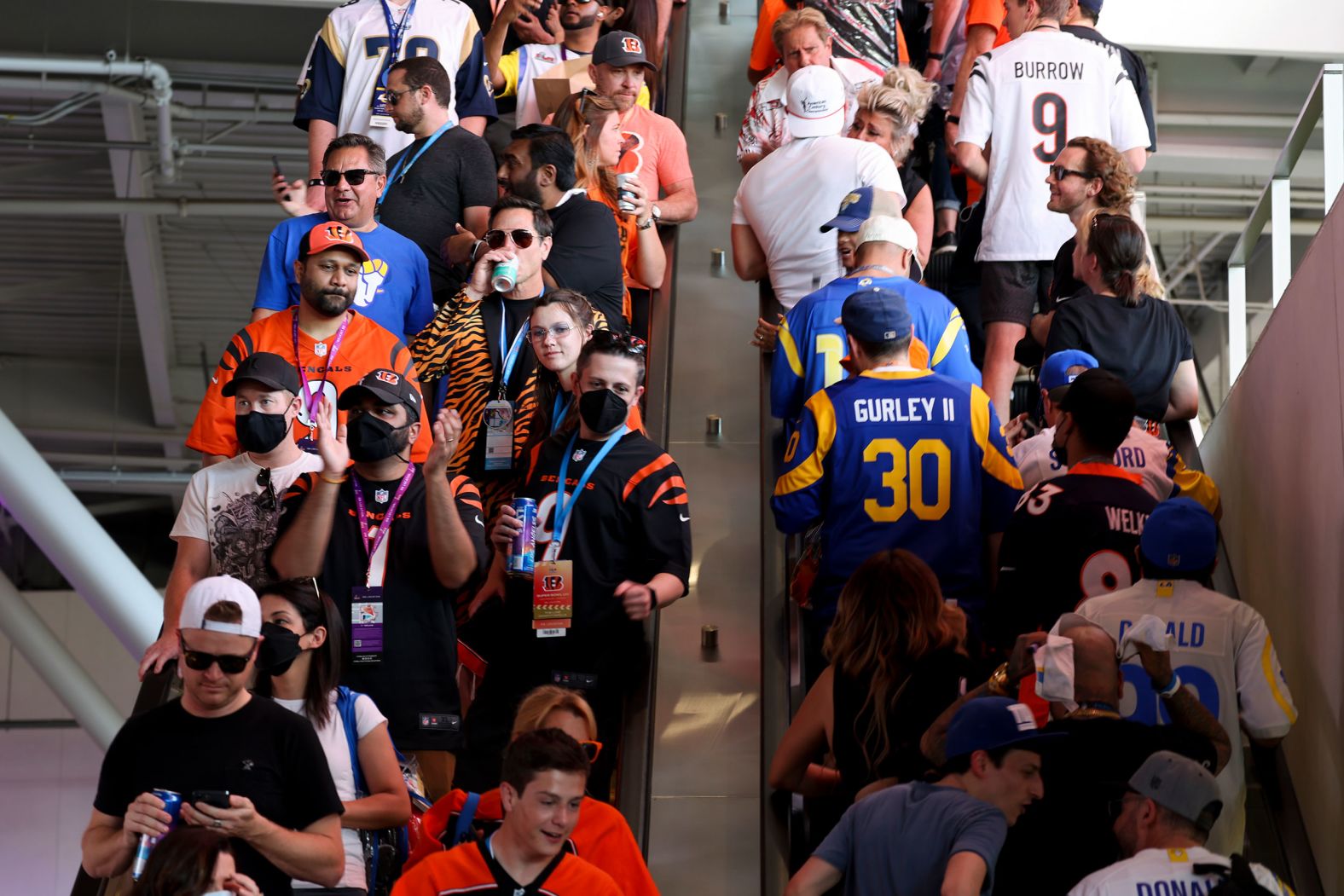 Fans ride escalators at SoFi Stadium before the game.