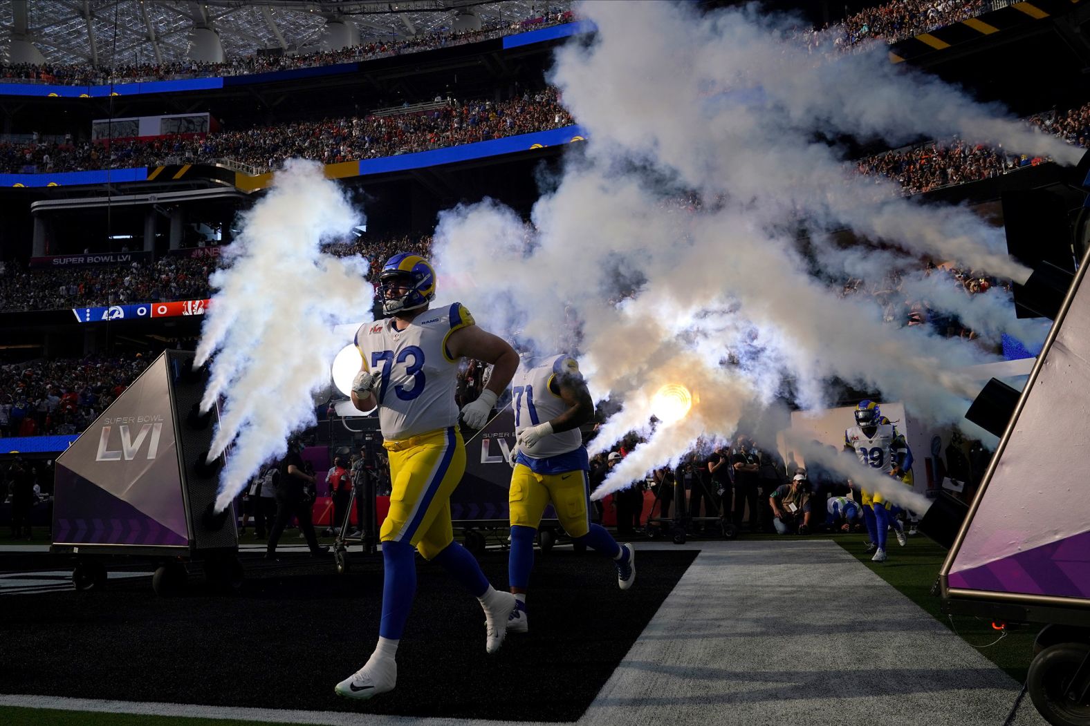 The Rams run onto the field before the start of the game.