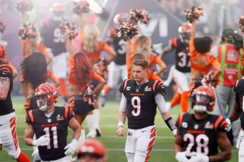 Burrow walks onto the field with the Bengals before the game.