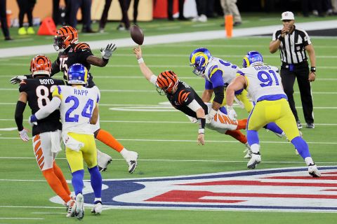 Bengals quarterback Joe Burrow flings the ball for an incomplete pass as he is pressured by Aaron Donald on a fourth-down play late in the game. The Rams then took over possession and ran out the clock.