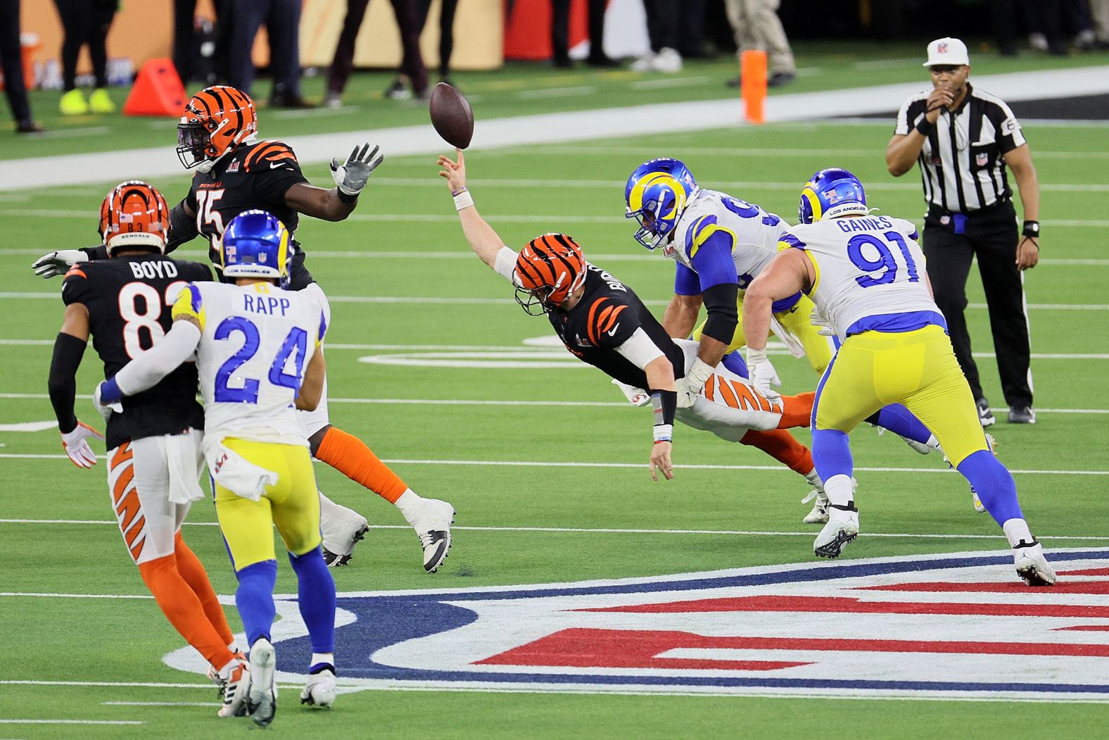 Bengals quarterback Joe Burrow flings the ball for an incomplete pass as he is pressured by Aaron Donald on a fourth-down play late in the game. The Rams then took over possession and ran out the clock.