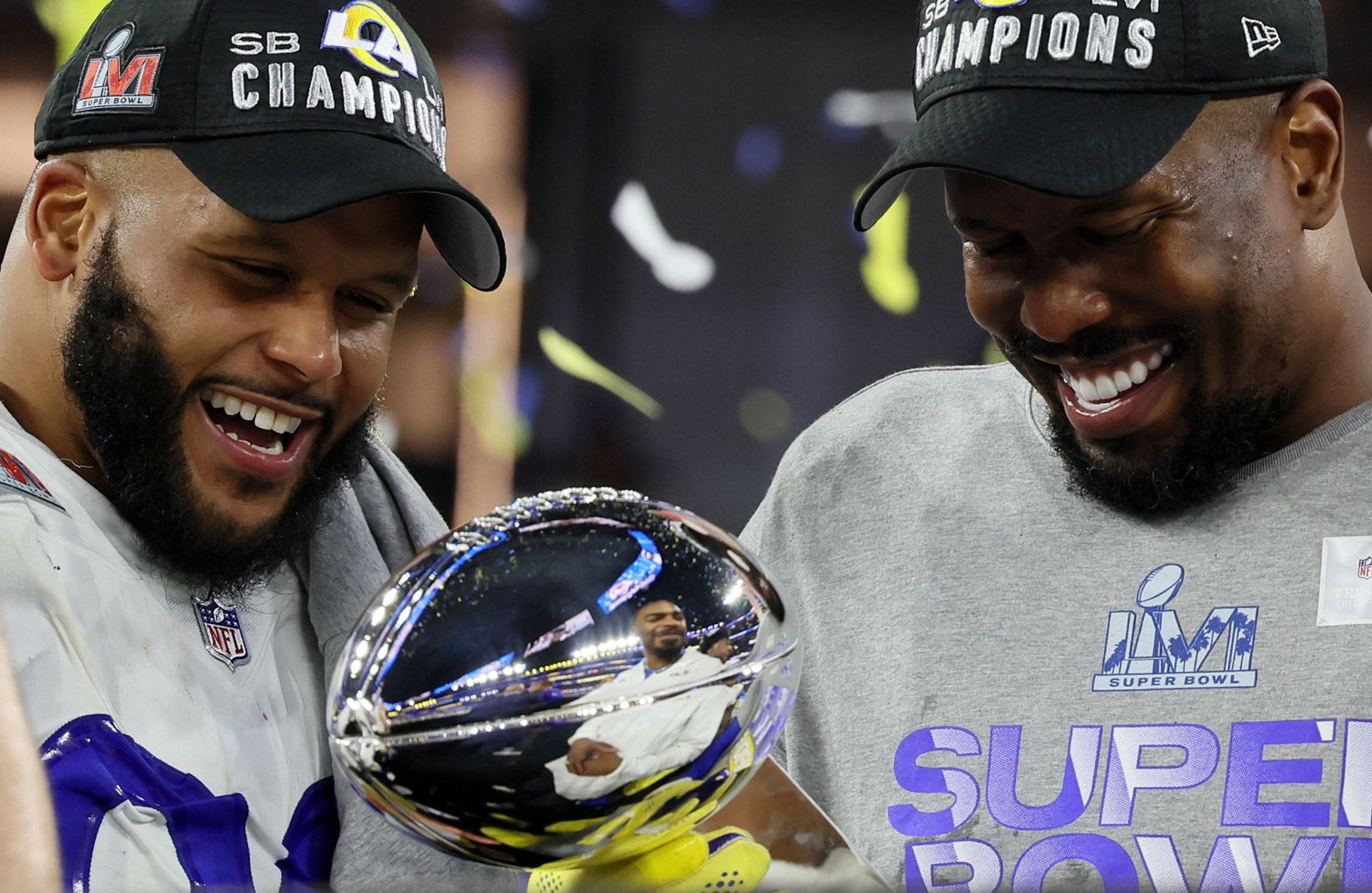 The Rams' Aaron Donald, left, and Von Miller admire the Lombardi Trophy after the game. Both had two sacks in the game.