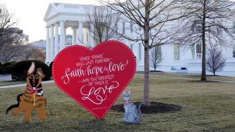 A Valentine's heart and depictions of President Joe Biden and first lady Jill Biden's pet dog Commander, left, and cat Willow, stand on the North Lawn of the White House in celebration of Valentine's Day, Monday, Feb. 14, 2022, in Washington.