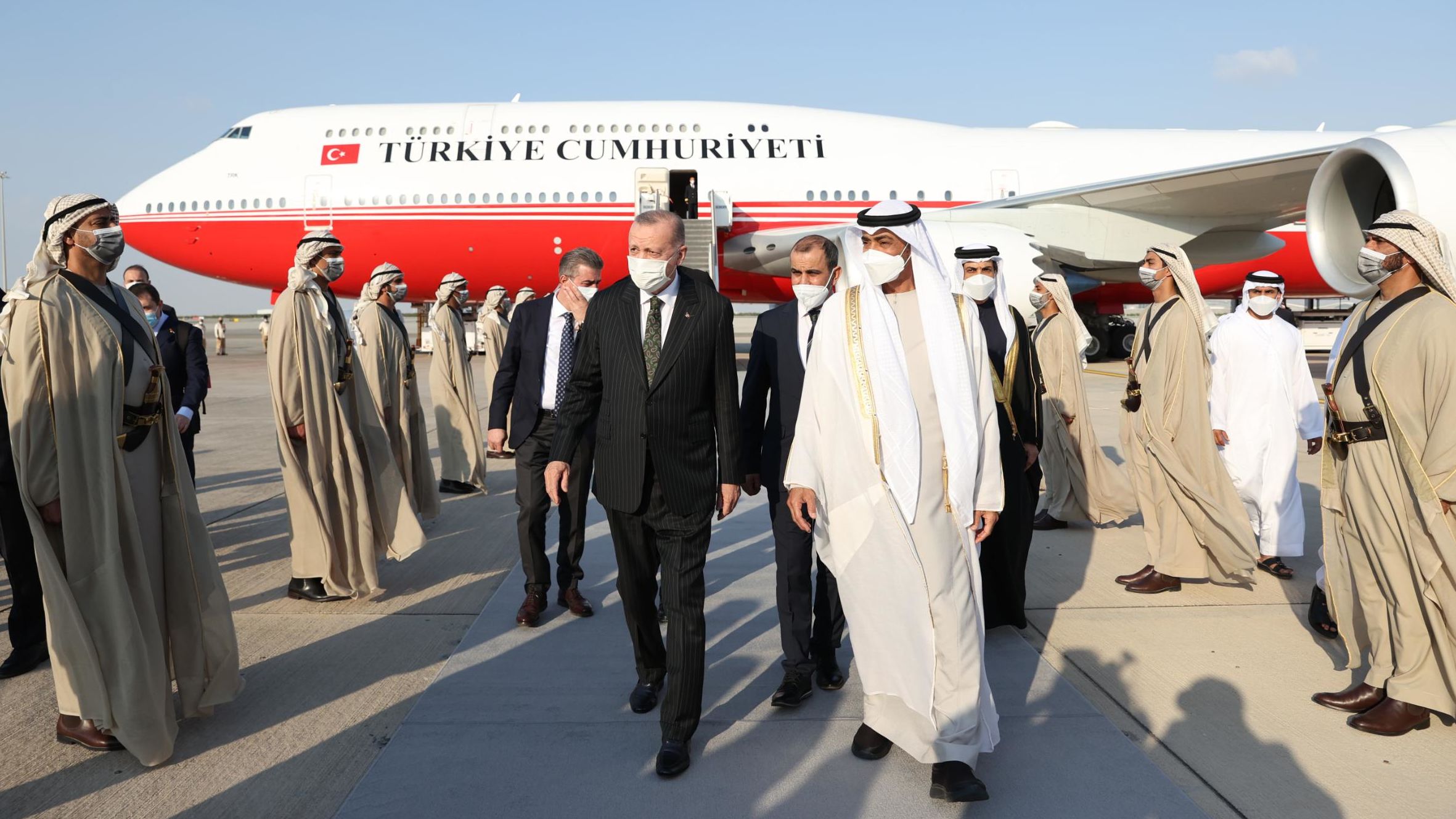 Turkish President Recep Tayyip Erdogan (L) is welcomed by Emirati officials after arriving at Abu Dhabi's international airport Monday. 