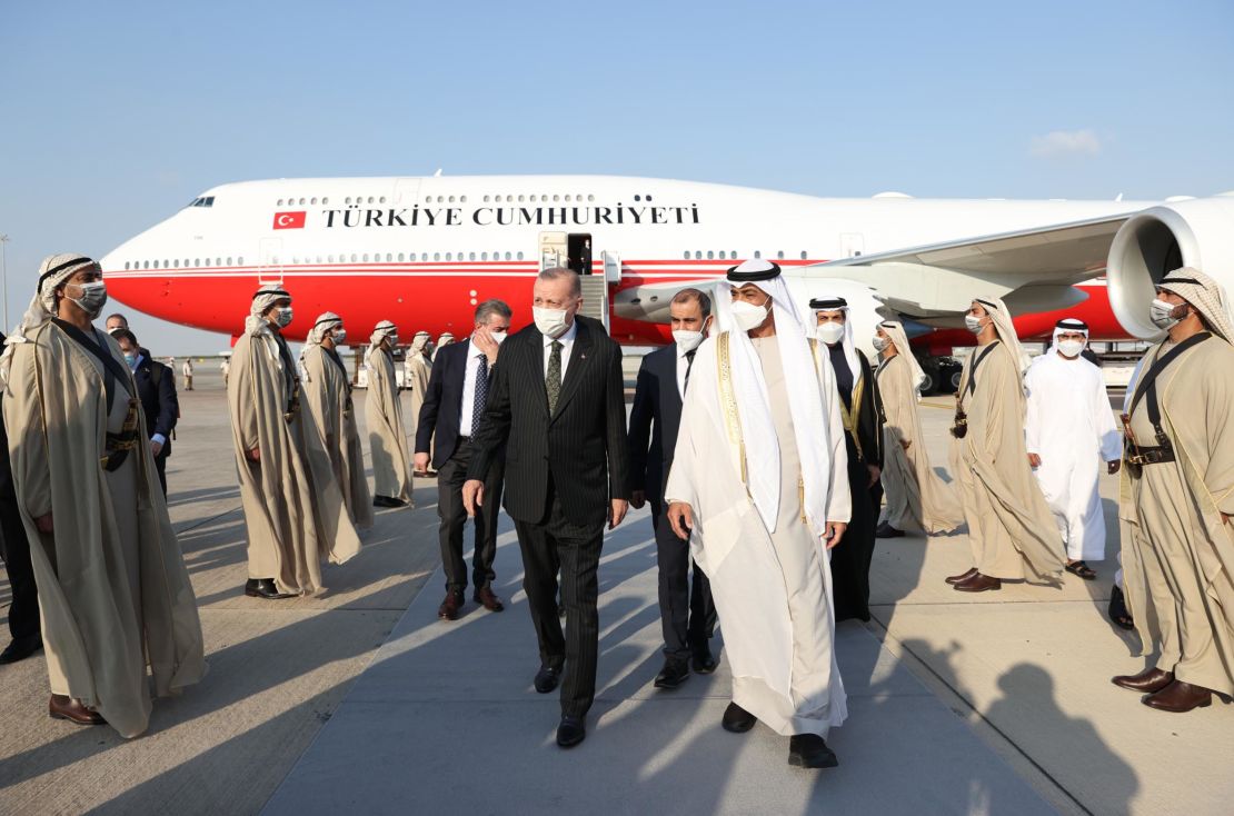 Turkish President Recep Tayyip Erdogan (L) is welcomed by Emirati officials after arriving at Abu Dhabi's international airport Monday.