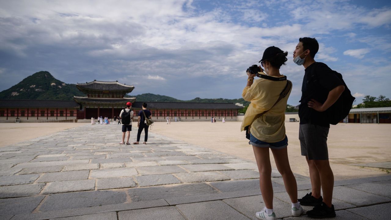South Korea moved to Level 4 on February 14. Here, visitors pose for photos at Gyeongbokgung Palace in Seoul on July 3, 2020. 