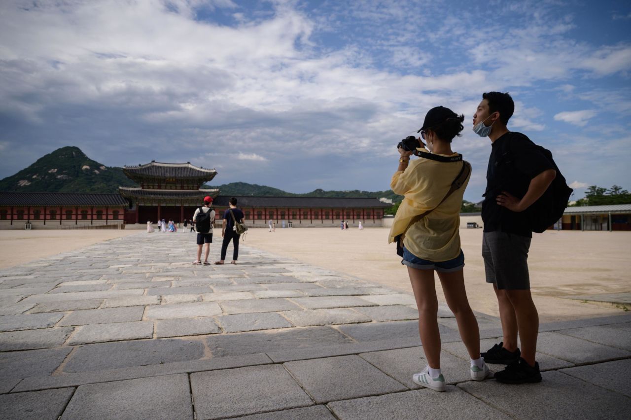 South Korea moved to Level 4 on Monday. Here, visitors pose for photos at Gyeongbokgung Palace in Seoul on July 3, 2020. 