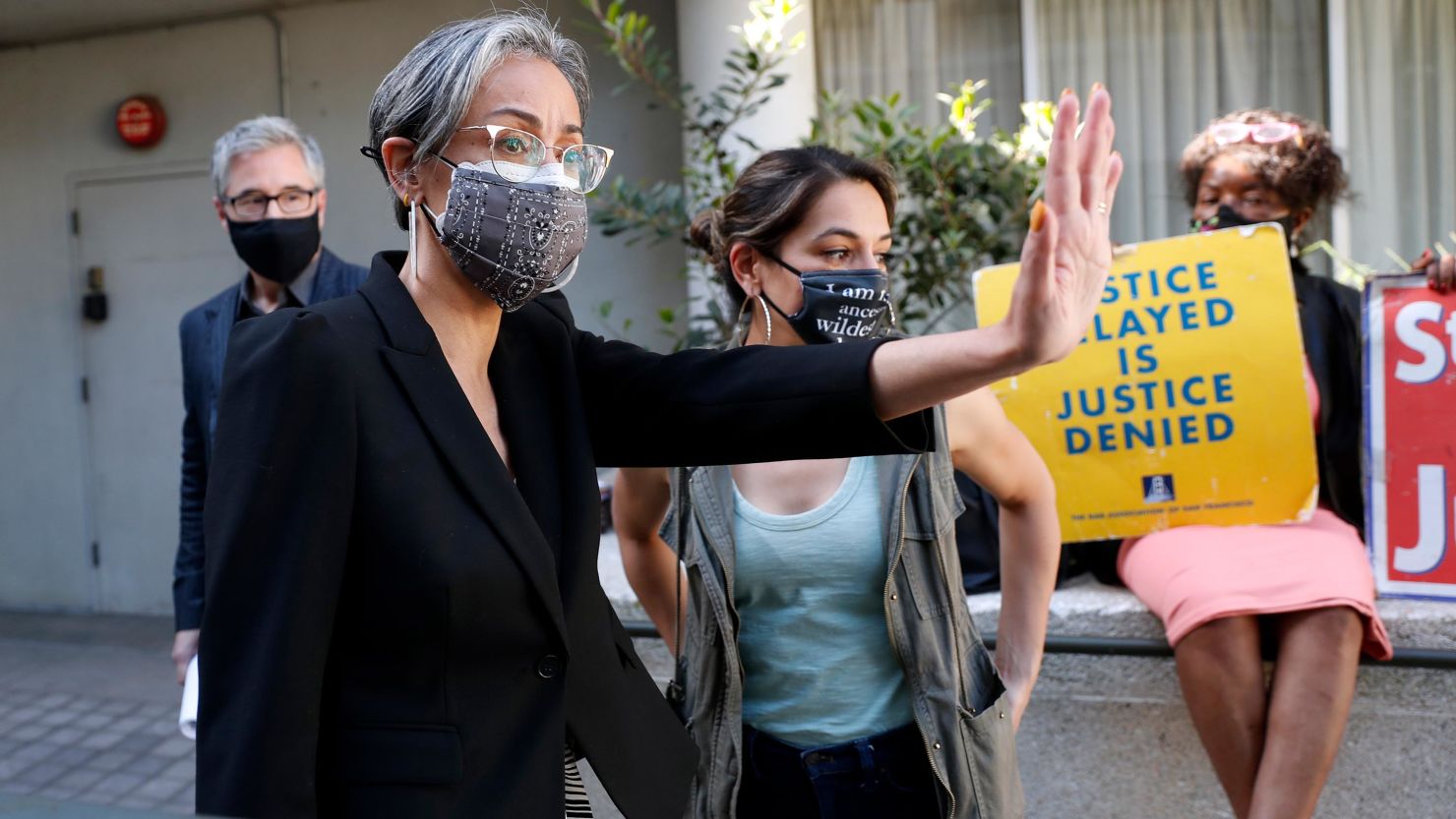 As she stands next to board President Gabriela Lopez, SFUSD commissioner Alison Collins waves to supporters before a rally in San Francisco, on Wednesday, March 31, 2021.