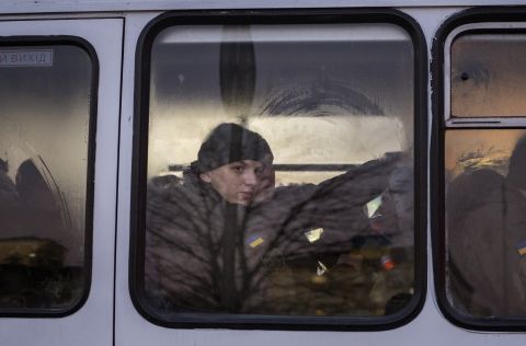 Members of Ukraine's National Guard look out a window as they ride a bus through the capital of Kyiv on February 14.