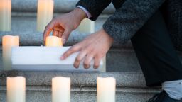 A Congressional staffer adjusts a candle prior to a Congressional remembrance for lives lost to COVID-19, at the U.S. Capitol, in Washington, D.C., on Tuesday, February 23, 2021. Congressional Leaders from both parties led more than 100 Representatives and Senators in a moment of silence and vigil on the steps of the Capitol in remembrance of the 500,000 American lives lost to COVID-19. (Graeme Sloan/Sipa USA)