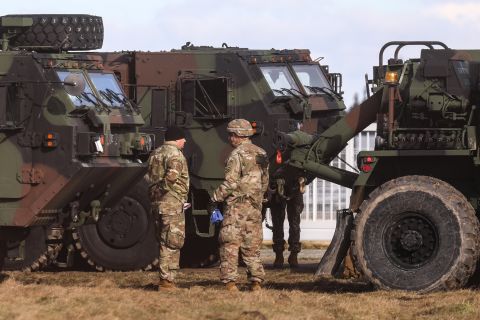US soldiers and military vehicles are seen at a military airport in Mielec, Poland, on February 12. The White House approved a plan for the nearly 2,000 US troops in Poland <a href=