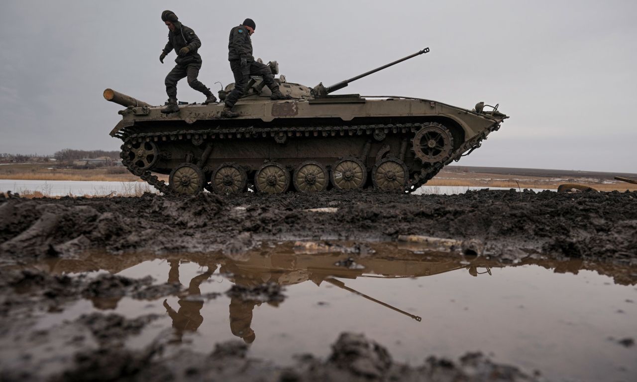 Ukrainian service members walk on an armored fighting vehicle during a training exercise in eastern Ukraine's Donetsk region on February 10.