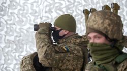 A Ukrainian Military Forces serviceman of the 92nd mechanised brigade uses binoculars live-fire exercises near the town of Chuguev, Kharkiv region on February 10, 2022. (Photo by Sergey BOBOK / AFP) (Photo by SERGEY BOBOK/AFP via Getty Images)