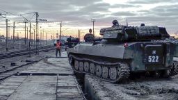 In this photo taken from video provided by the Russian Defense Ministry Press Service on Tuesday, Feb. 15, 2022, Russian armored vehicles are loaded onto railway platforms after the end of military drills in South Russia. In what could be another sign that the Kremlin would like to lower the temperature, Russia's Defense Ministry announced Tuesday that some units participating in military exercises would begin returning to their bases. (Russian Defense Ministry Press Service via AP)