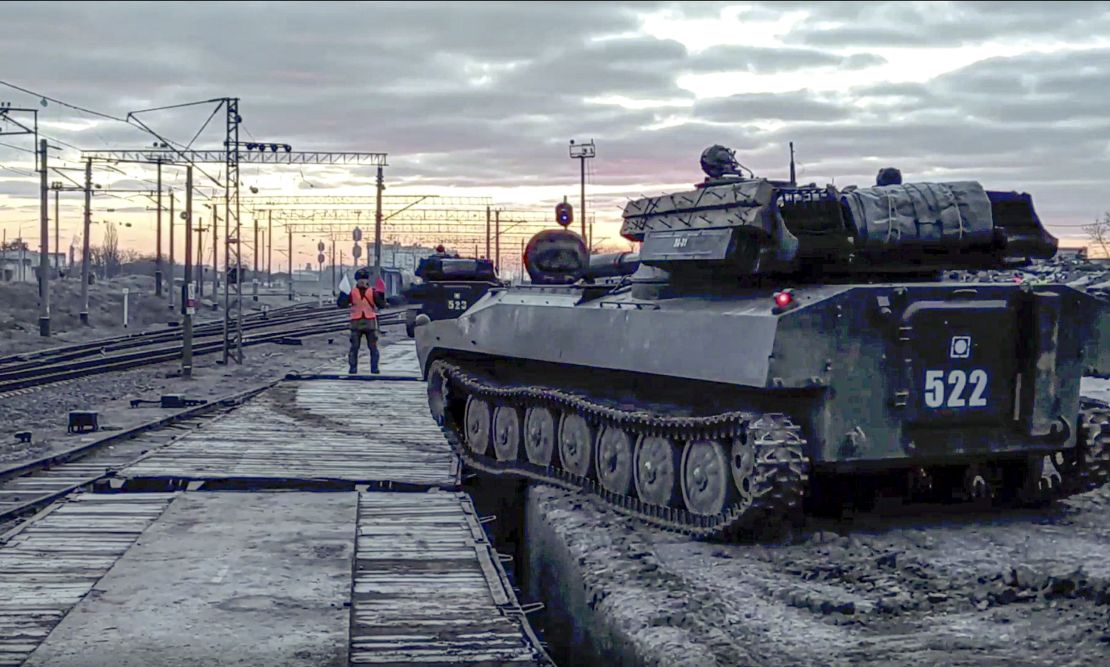 In this photo taken from video provided by the Russian Defense Ministry on Tuesday, Russian armored vehicles are loaded onto railway platforms after the end of military drills.