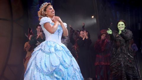 Brittney Johnson, the first full-time "Glinda" played by a woman of color, takes a bow and makes Broadway history at The Gershwin Theater on February 14, 2022 in New York City, as Lindsay Pearce (playing "Elphaba," right) and the cast of "Wicked" cheer for her. 