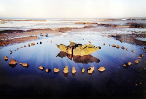Seahenge, a timber circle with an upturned oak stump at the center, was revealed by shifting sands on Holme Beach in Norfolk, Eastern England, in 1998. Some think the oak stump might have supported a dead body during funeral rituals.