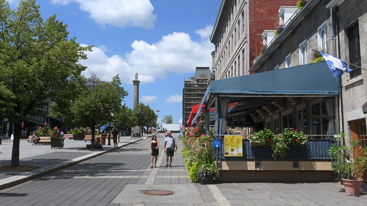 Tourists walks down Place Jacques-Cartier in Old-Montreal, Canada on July 28, 2020. - Stripped of the crowds of visitors that usually flock to its sights, from the Grand Prix to its renowned festivals, Montreal is trying to reinvent itself during the coronavirus pandemic and salvage what is left of its summer. (Photo by Eric THOMAS / AFP) (Photo by ERIC THOMAS/AFP via Getty Images)