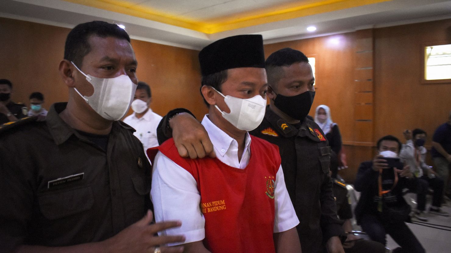Indonesian teacher Herry Wirawan (center) at a court in Bandung, West Java on February 15, 2022.