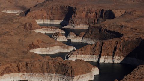 The "bathtub ring," showing how far the water level has dropped, is visible on the rocky banks of Lake Powell on June 24, 2021, in Page, Arizona.