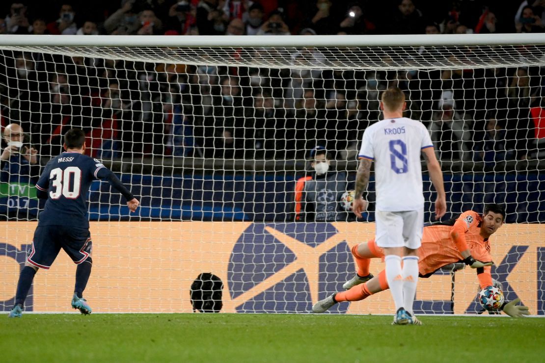 Real Madrid's goalkeeper Thibaut Courtois stops a penalty-kick by Lionel Messi.