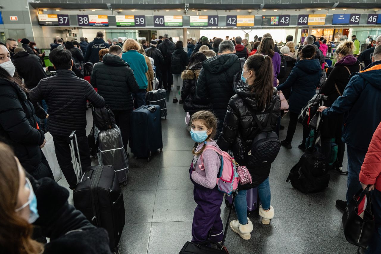 Travelers wait in line to check in to their departing flights February 15 at the Boryspil International Airport outside Kyiv. US President Joe Biden<a target=