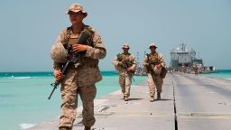 U.S. Marines walking to an  American ship docked near a military base in the United Arab Emirates during a military exercise on March 23, 2020.