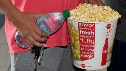 Alejandro Castaneda of Nevada gets a bottle of water and a bucket of popcorn before seeing a movie at AMC Town Square 18 on August 20, 2020 in Las Vegas, Nevada. 