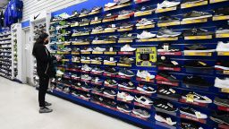 A woman shops for shoes at a sporting goods store in Alhambra, California on January 28, 2022.