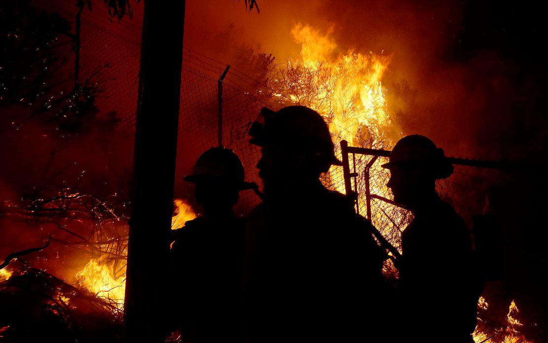 California firefighters battle wildfires day and night as homes are threatened nearby.