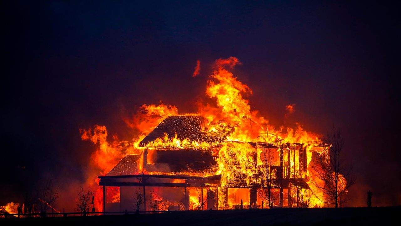 A Colorado home burns beneath the nighttime sky, as studies now show wildfires are becoming more intense at night.