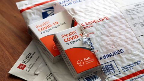 In this photo illustration, free iHealth COVID-19 antigen rapid tests from the federal government sit on a U.S. Postal Service envelope after being delivered. (Photo Illustration by Justin Sullivan/Getty Images)