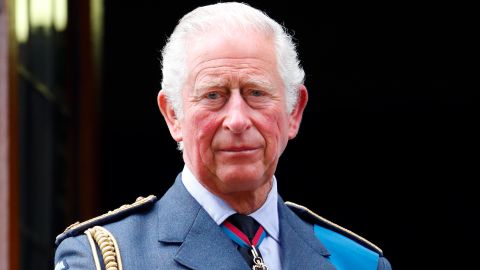 Prince Charles watches a Spitfire and Hurricane fly-past from the balcony of Church House on September 19, 2021 in London, England.