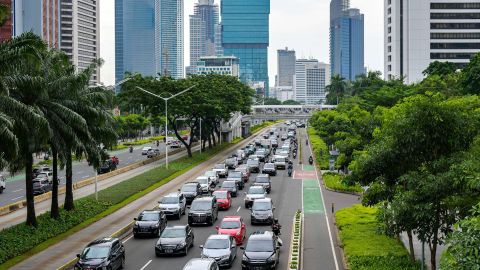Vehicles crowd a main road leading out Jakarta during the early evening rush hour on November 30, 2021.