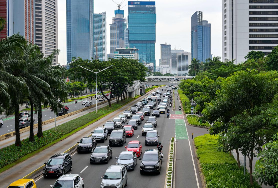 Vehicles crowd a main road leading out Jakarta during the early evening rush hour on November 30, 2021.