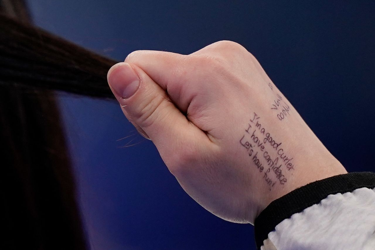 Japan's Satsuki Fujisawa plays with her hair during a curling match against China on February 14. She had a message to herself written on her hand: "I'm a good curler. I have confidence. Let's have fun!"
