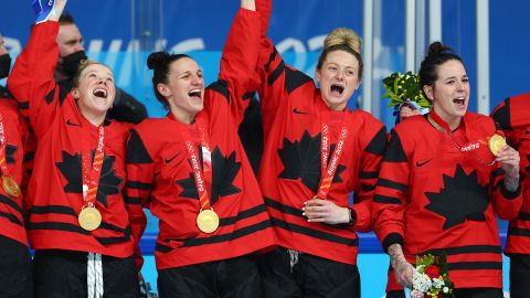 (Left to right) Sarah Fillier, Jill Saulnier, Renata Fast and Melodie Daoust celebrate with their gold medals after beating Team USA.