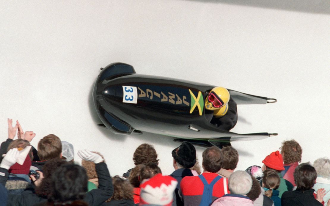 Jamaica's first-ever bobsledders, pilot Dudley 'Tal' Stokes and brakeman Michael White, are cheered on by fans during the first run of the Olympic two-man bobsled event February 20, 1988 at the Canada Olympic Park in Calgary. Stokes and White placed 31st out of 41.