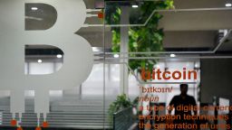The cryptocurrency symbol of Bitcoin is pictured at the entrance of a private office in Bangalore, India, on November 23, 2021.