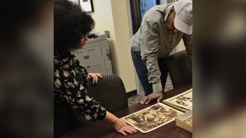 Dorothy Berry shows materials from the Richard E. Norman Collection to actor Danny Glover at the Black Film Center/Archive.