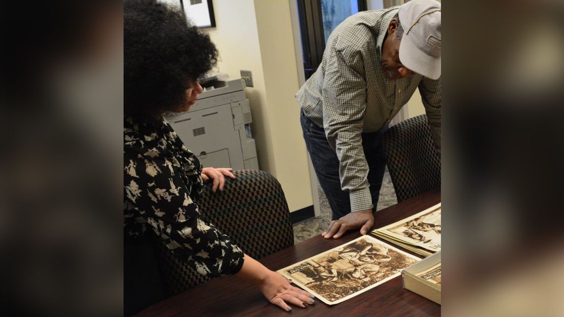 Dorothy Berry shows materials from the Richard E. Norman Collection to actor Danny Glover at the Black Film Center/Archive.