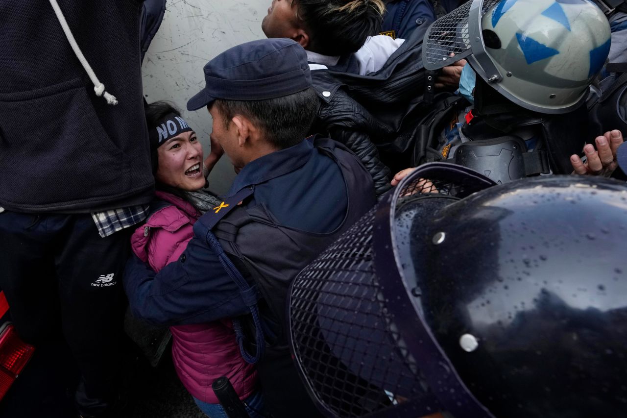 Police officers detain a protester outside Nepal's parliament in Kathmandu on Wednesday, February 16. People were protesting a proposed US grant of $500 million. The money is meant to be used for power line construction and road improvements, but there has been growing opposition to it, mainly led by communist parties who say it comes with conditions not acceptable for the country.