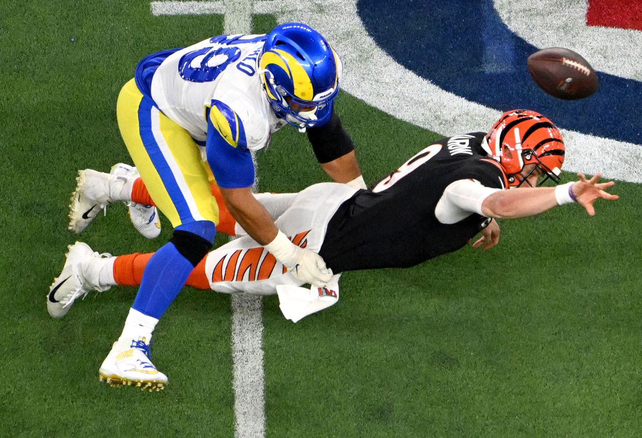 Cincinnati quarterback Joe Burrow flings the ball for an incomplete pass as he is pressured by the Los Angeles Rams' Aaron Donald on a fourth-down play late in the <a href="http://www.cnn.com/2022/02/13/sport/gallery/best-photos-2022-super-bowl/index.html" target="_blank">Super Bowl</a> on Sunday, February 13. The Rams then took over possession and ran out the clock.