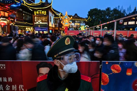A police officer works at the Yu Garden in Shanghai, China, as people celebrate the Lantern Festival and mark the end of the <a href="http://www.cnn.com/2022/02/01/world/gallery/lunar-new-year-2022-photos/index.html" target="_blank">Lunar New Year holiday</a> on Tuesday, February 15. This photo was taken with a slow shutter speed.